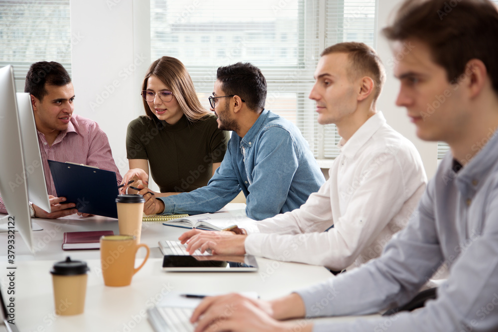 Multy-ethnic group of business people working at office Multy-ethnic group of business people working at office