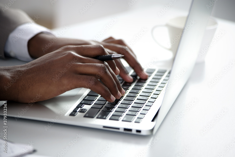 Close-up of hands of african american businessman typing on a keyboard. Close-up of hands of african american businessman typing on a keyboard.