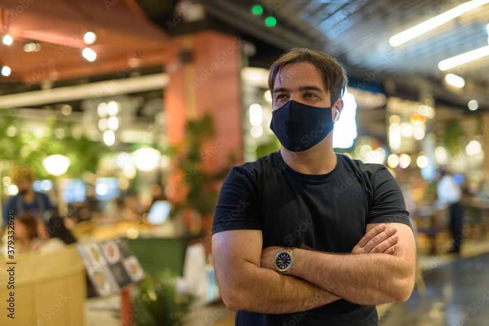 Portrait of Persian man with mask thinking at the mall indoors Portrait of Persian man with mask thinking at the mall indoors