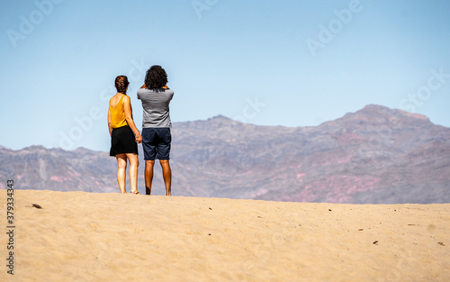 Couple with a view from Dead valley national park . One of the most famous and beautiful desert national park locate in Nevada , California , United States of America