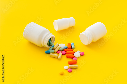 Bilde på lerret Medical pills and tablets spilling out of bottle, copy space