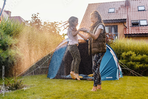 Family having fun camping in their house garden