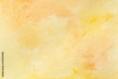 Abstract watercolor on paper wallpaper. Hand painted orange and yellow watercolor background.