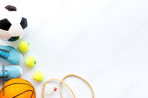 Flat lay of sport balls - football, basketball on white background copy space