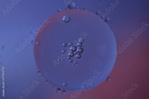 Fantastic oil drops on ble-purple background