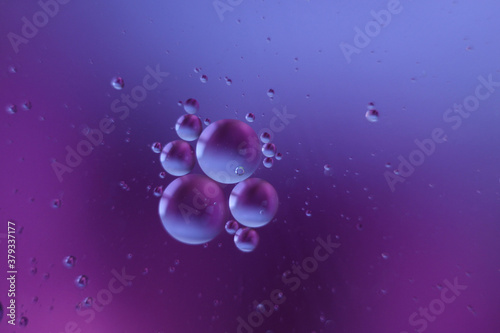 Fantastic oil drops on ble-purple background
