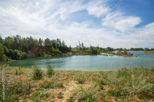 Flooded open pit quarry with blue water lake