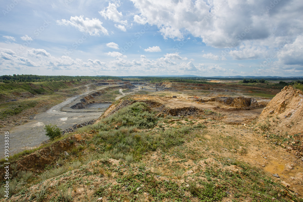 Big open pit limestone quarry mine with working drilling machines, excavators, trucks Big open pit limestone quarry mine with working drilling machines, excavators, trucks