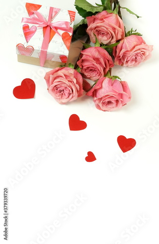 Bouquet of pink roses flowers, gift box  and red hearts confetti isolated  on...