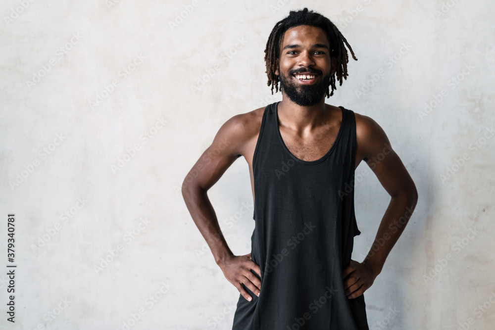 Image of african american sportsman smiling at camera while working out Image of african american sportsman smiling at camera while working out