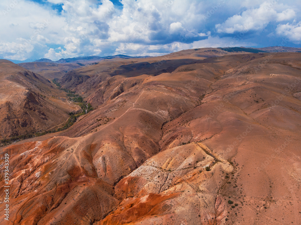 Aerial drone panorama of colorful eroded landform of Altai mountains with yellow, brown and red colors. Nature landscape in popular tourist location called Mars, near the border with Mongolia, Chagan