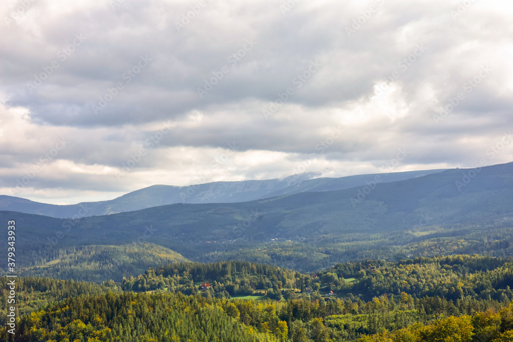 View from above on green fields, forests and mountains in the Karkonosze Mountains of Poland.
