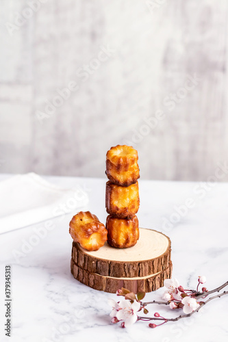Selective focus to canelé cake - a small french pastry flavored with rum and vanilla on the table.