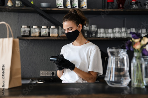 Woman bartender wearing medical mask