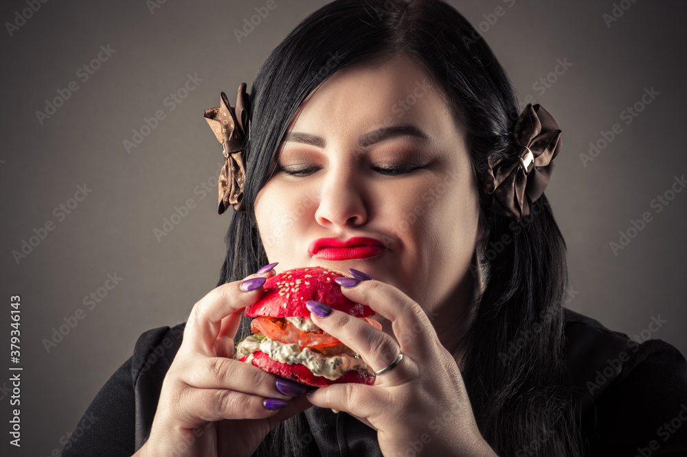 fat woman happy looking at hamburger closeup
