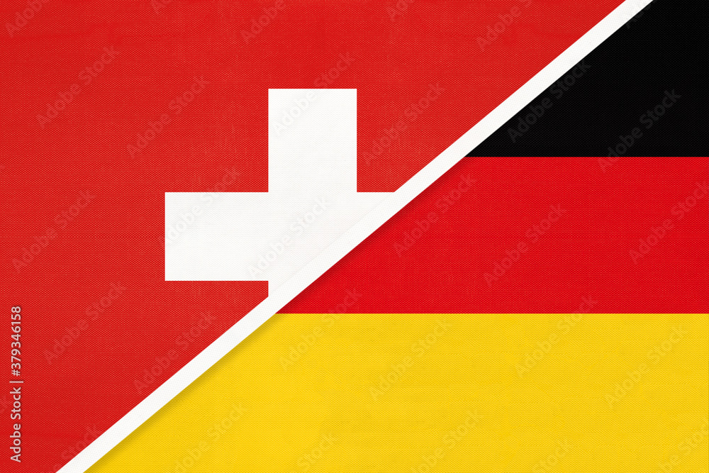 Fototapeta premium Switzerland and Germany, symbol of national flags from textile. Championship between two countries.