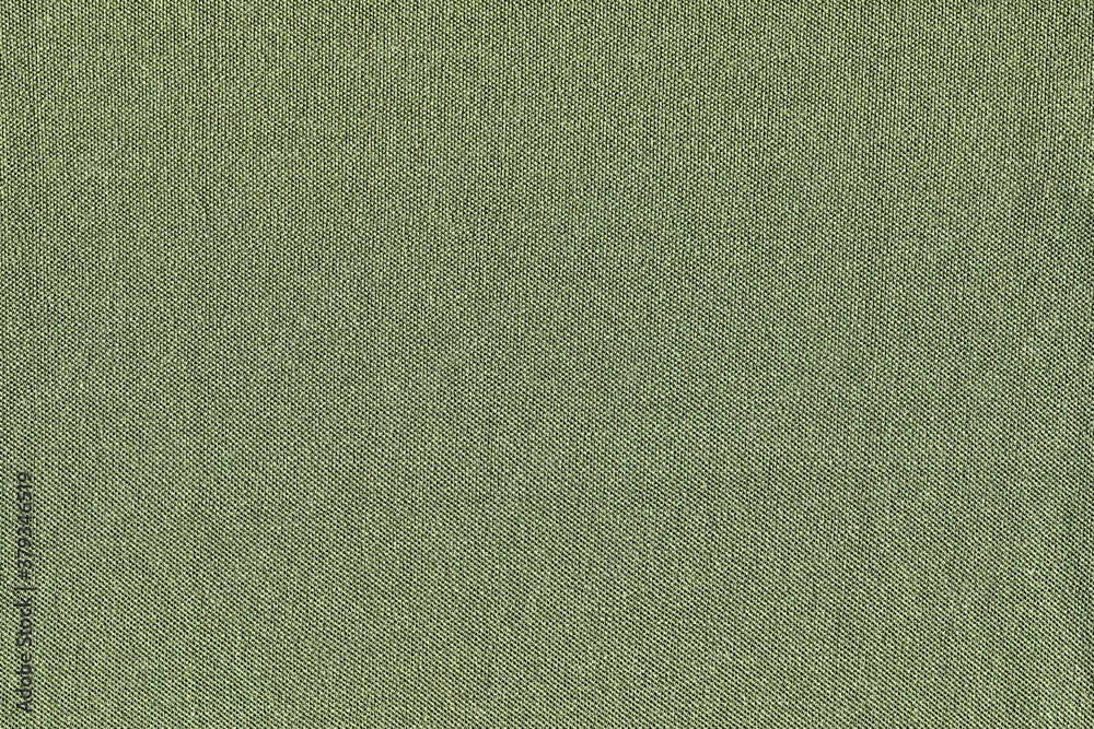 Fototapeta premium The texture of natural cotton knitted fabric is green, like grass, color. Soft cotton simple fabric in green color. Abstract background.