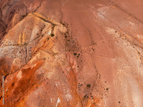 Aerial drone view of colorful eroded landform of Altai mountains with yellow, brown and red colors. Nature landscape in popular tourist location called Mars, near the border with Mongolia, Chagan-Uzun