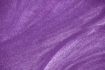 de-focused. Abstract elegant, detailed purple glitter particles flow underwater. Holiday magic shimmering luxury background. Festive sparkles and lights.