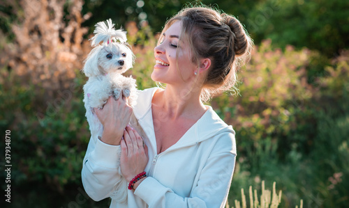Woman with a Little fashionable luxury lapdog dog at walk  pet lifestyle