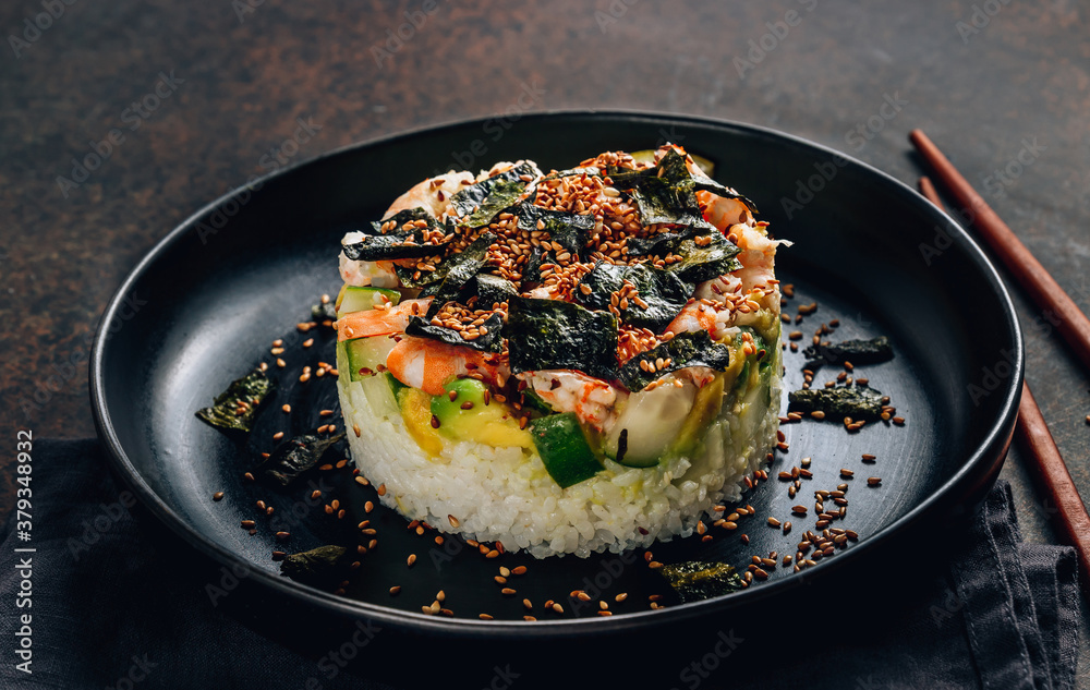 Spicy shrimp sushi stacks with layers of sushi rice, cucumbers and avocado spicy shrimp and furikake Spicy shrimp sushi stacks with layers of sushi rice, cucumbers and avocado spicy shrimp and furikake