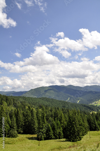 beautiful mountain landscape with colorful bright clouds and sunshine in the sky, fantastic outdoor background