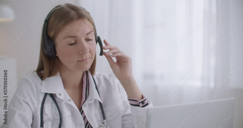 health professional woman is consulting patients by telephone, using headphones with microphone, distant consultation health professional woman is consulting patients by telephone, using headphones with microphone, distant consultation