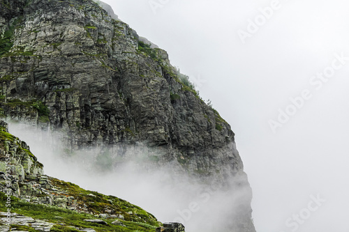 Fog, clouds, rocks and cliffs on Veslehødn Veslehorn mountain, Norway. photo