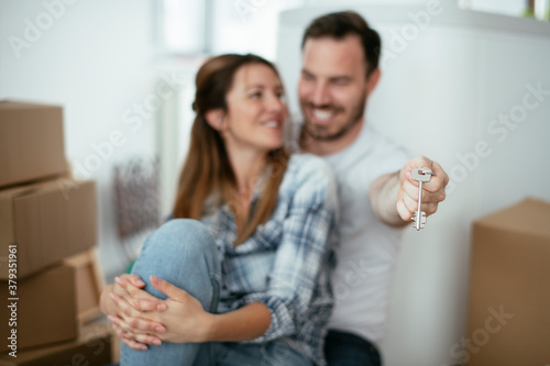 Close up of husband and wife holding the key to their new apartment...