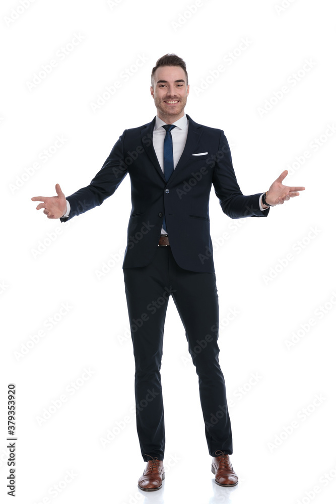 Positive businessman welcoming and smiling while standing Positive businessman welcoming and smiling while standing