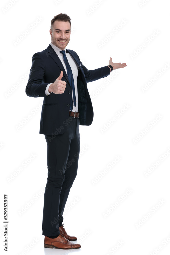 Side view of smiling businessman gesturing ok and presenting Side view of smiling businessman gesturing ok and presenting