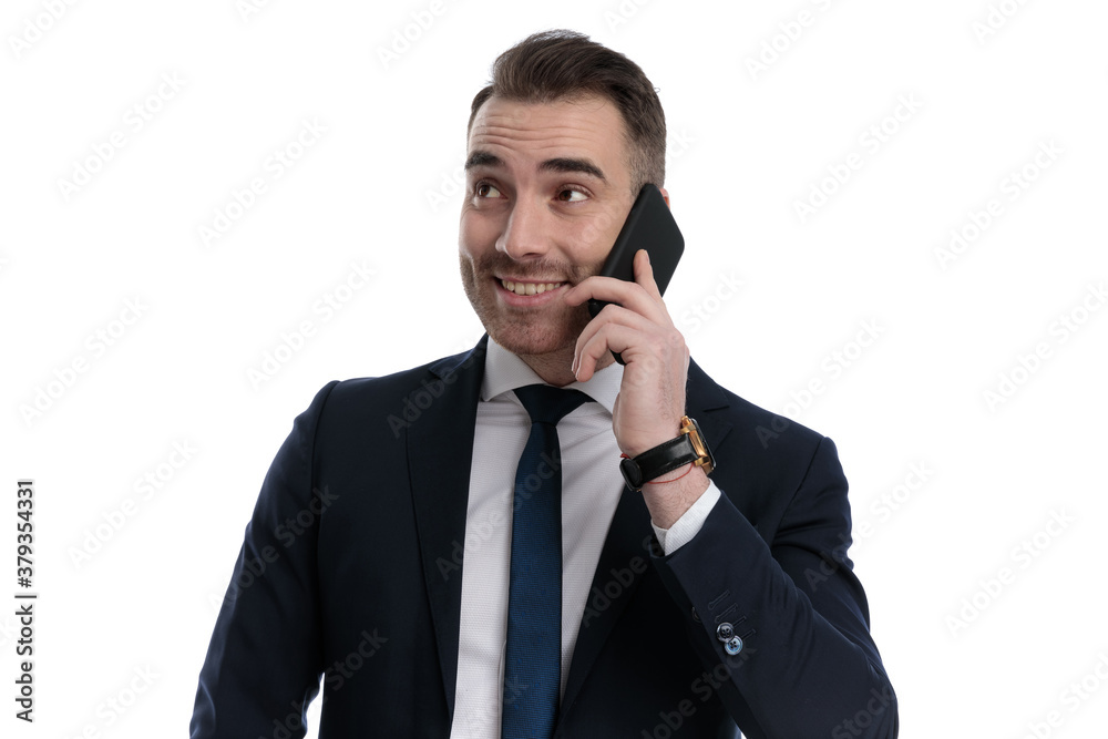 Cheerful businessman talking on mobile and smiling Cheerful businessman talking on mobile and smiling
