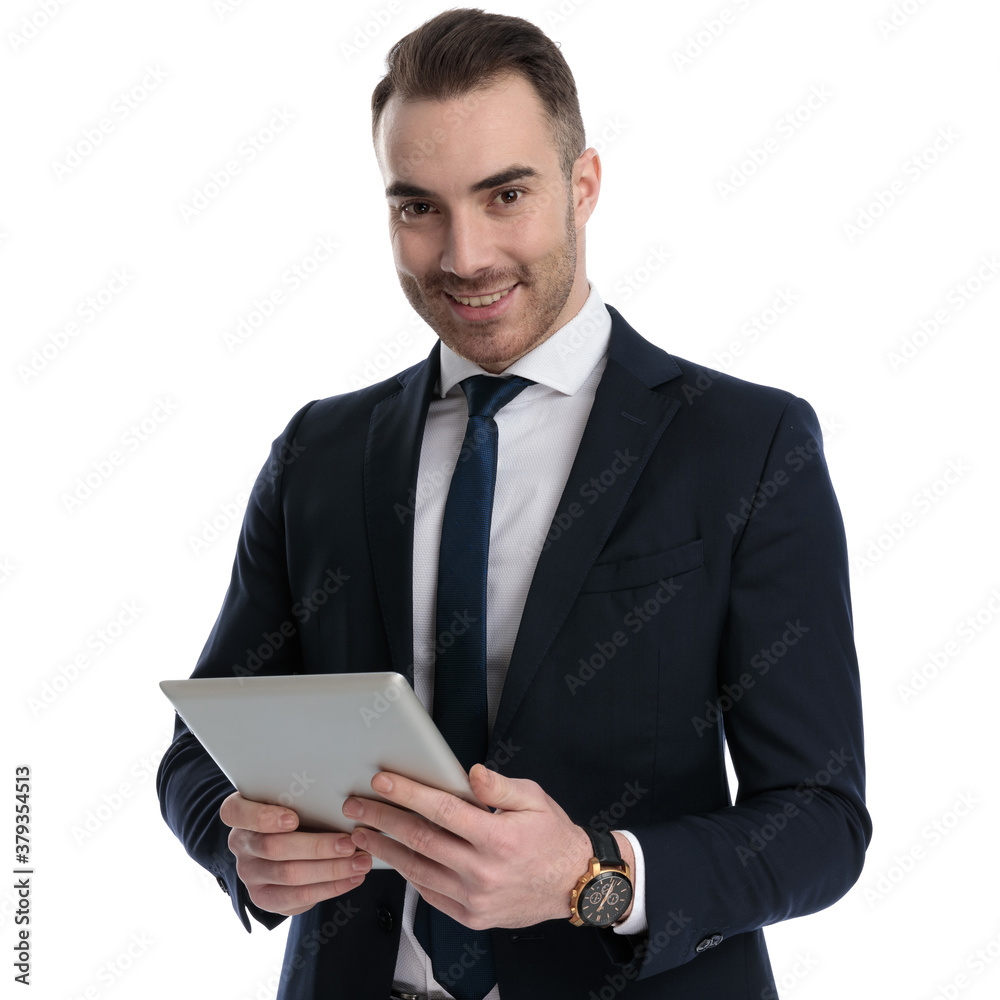 Happy businessman smiling and holding tablet Happy businessman smiling and holding tablet