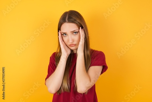 Beautiful Young beautiful caucasian girl wearing red t-shirt over isolated yellow background Tired hands covering face, depression and sadness, upset and irritated for problem