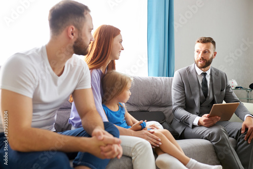 young caucasian family expain situation, problems to family psychologist. professional therapist attentively listen to them, try to help, give advices. last chance to save the family