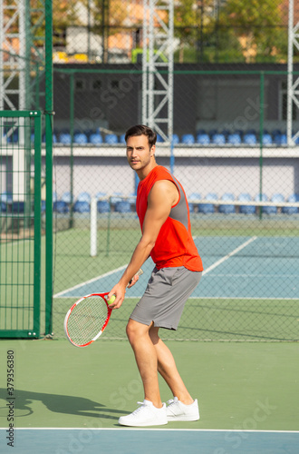 Handsome sportsman playing tennis on tennis court © rilueda