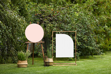 empty board stands on green lawn on wedding. invitation for guests for summer wedding ceremony