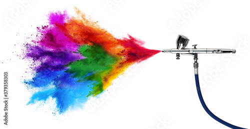 professional chrome metal airbrush acrylic color paint gun tool with colorful rainbow spray holi powder cloud explosion isolated white panorama background. industry art scale model modelling concept photo