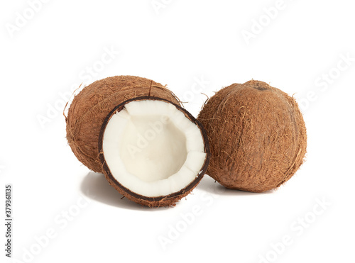 whole round and split in half ripe coconut isolated on white background