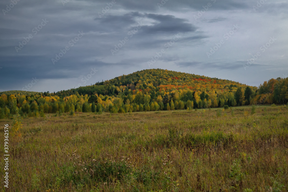 Majestic sunset in the mountains forest. Dramatic sky. Ural mountains. Majestic sunset in the mountains forest. Dramatic sky. Ural mountains.