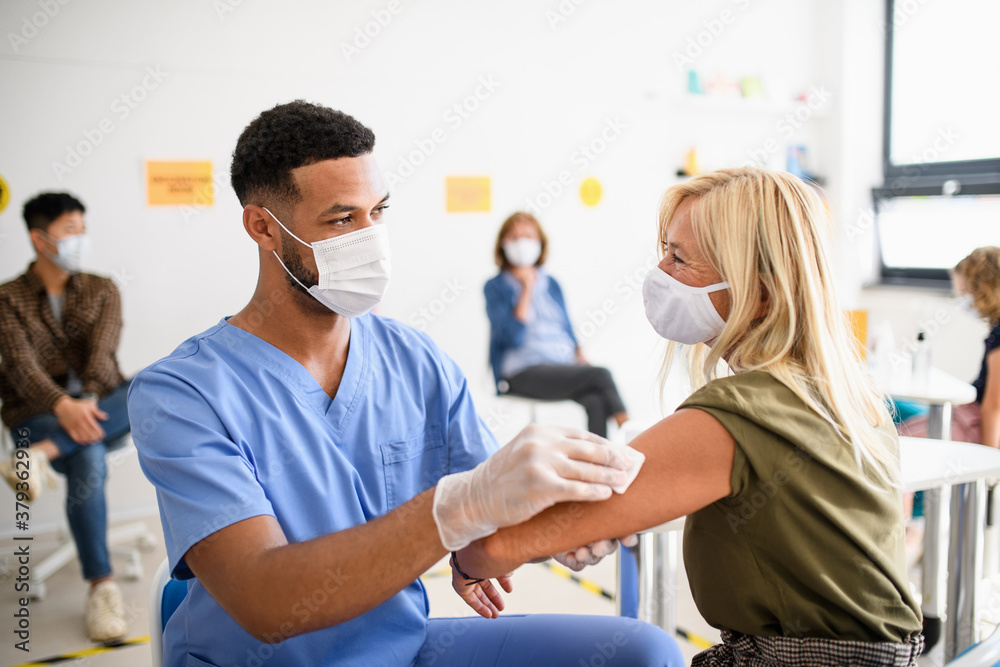 Old woman with face mask getting vaccinated, coronavirus, covid-19 and vaccination concept. Old woman with face mask getting vaccinated, coronavirus, covid-19 and vaccination concept.