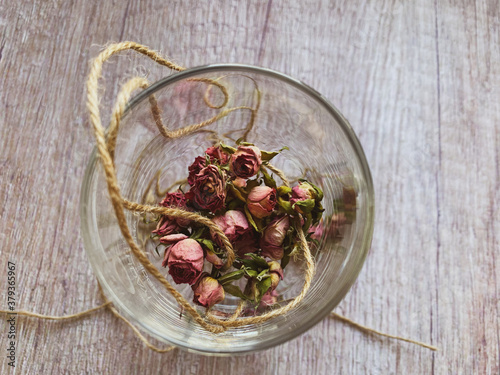 Dried rose buds on a light background