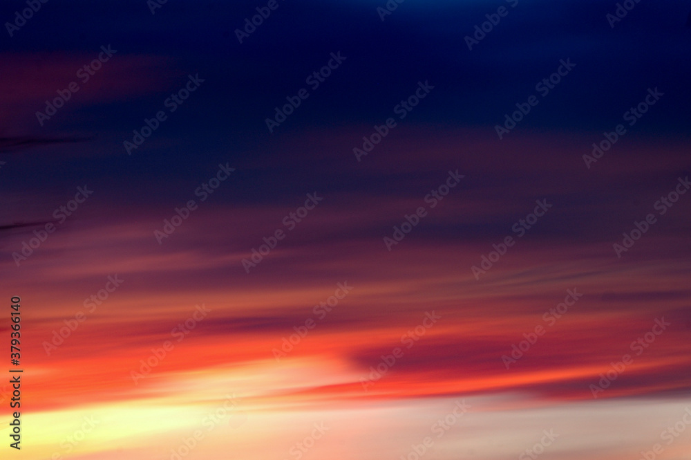 Sunset with long red horizontal clouds, dream scenario
