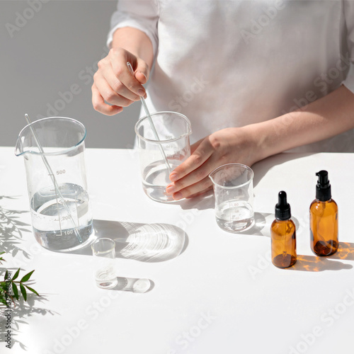 The scientist, dermatologist testing the organic natural cosmetic product in the laboratory. Vials, glass laboratory flasks. Beauty cosmetic research and development concept.