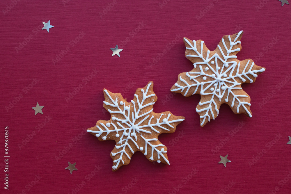 Christmas baking lies on a red background. Christmas gingerbread snowflakes lie for the gala dinner Christmas baking lies on a red background. Christmas gingerbread snowflakes lie for the gala dinner