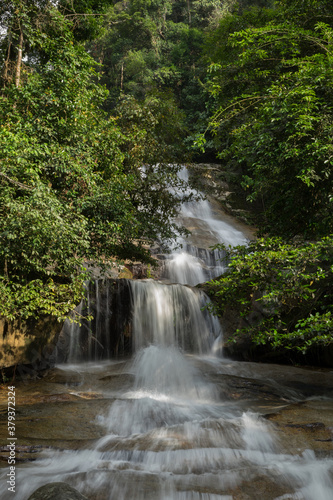 Fototapeta Naklejka Na Ścianę i Meble -  Beautiful rainforest waterfall in slow shutter mode.