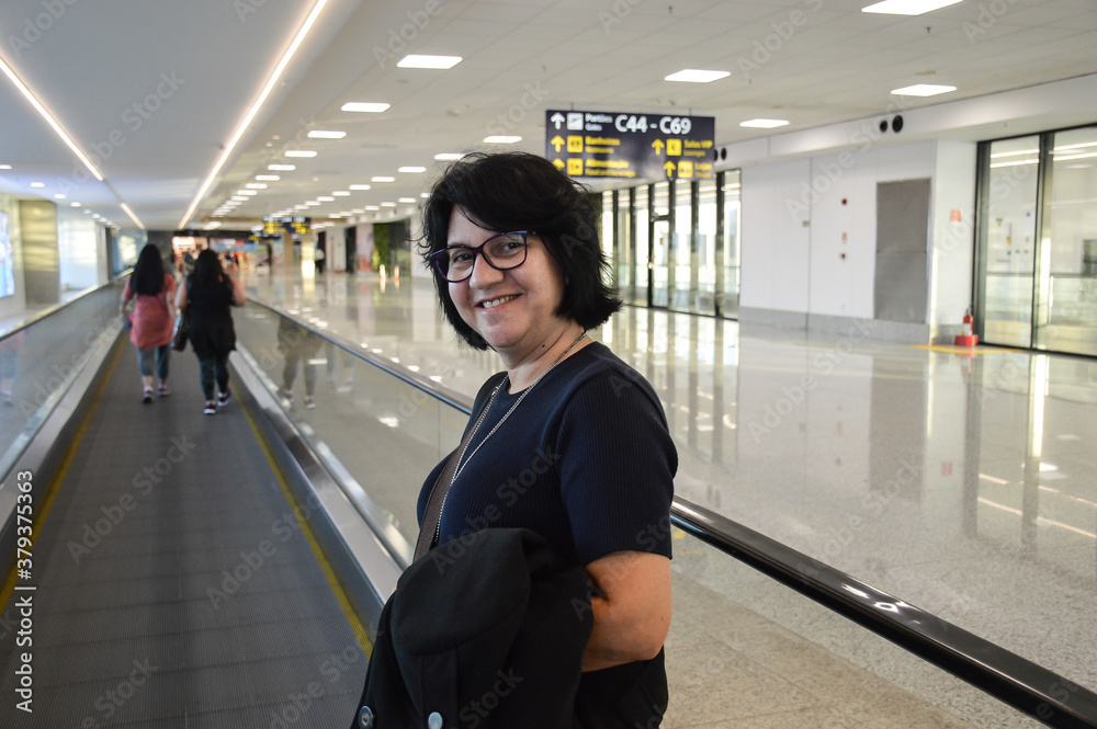 woman with happy face on airport conveyor belt