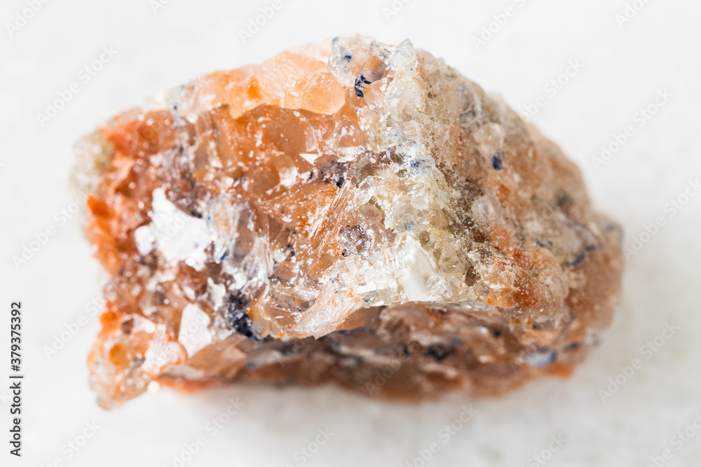 closeup of sample of natural mineral from geological collection - unpolished red Rock Salt (Halite) on white marble background from Perm Krai, Russia closeup of sample of natural mineral from geological collection - unpolished red Rock Salt (Halite) on white marble background from Perm Krai, Russia