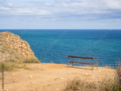 bench near seashore with view over the sea