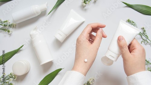 фотографія Scientist/Pharmacist applying moisturizer lotion on her hand for efficacy testing of natural organic skincare products in laboratory